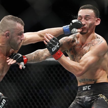 UFC featherweight champion Alexander Volkanovski hits Max Holloway in their featherweight title bout at UFC 245 in Las Vegas, Nevada, in December 2019. Photo: AP