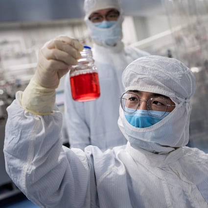 An engineer looks at monkey kidney cells as he conducts a test of an experimental vaccine for the Covid-19 coronavirus at the Sinovac Biotech facilities in Beijing on April 29. Photo: AFP