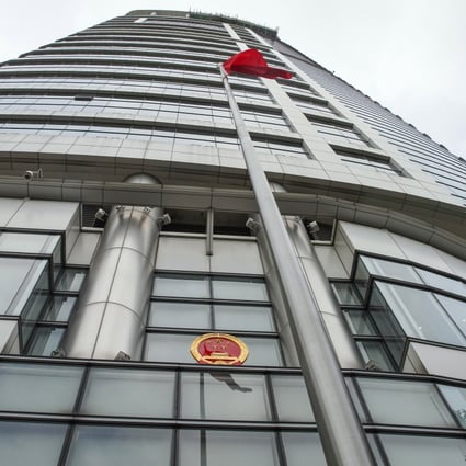 The Chinese flag and national emblem outside the temporary base for Hong Kong’s new Office for Safeguarding National Security. Photo: Winson Wong