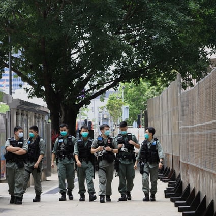 A group of police officers patrol outside government headquarters in Admiralty. Photo: May Tse