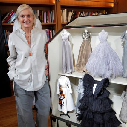 Maria Grazia Chiuri, designer for fashion house Dior, poses next to her haute couture creations on miniature mannequins. The dolls in couture echo a similar show French couturiers put together amid post-war austerity in 1945, and which kick-started an haute couture renaissance. Photo: Reuters