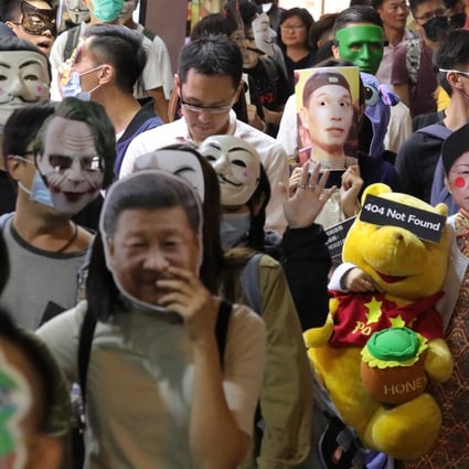 Mask-wearing anti-government protesters march in Causeway Bay on Halloween night. Photo: May Tse