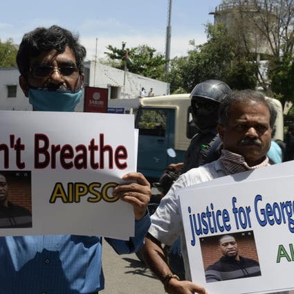 Members of the All India Peace and Solidarity Organisation hold placards in a silent protest in front of the Consulate General of the United States in Hyderabad on June 4 in solidarity over the death of George Floyd. Photo: AFP
