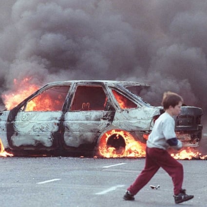 A burning car in the Catholic area of Shortstrand during the Troubles in Belfast in 1996. Photo: AFP