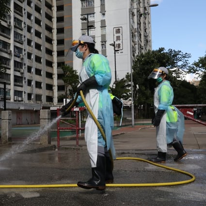 Workers in protective gear disinfect the streets on July 5 in and around Long Ping Estate in Yuen Long, where a 59-year-old man living in one of the flats contracted coronavirus. It was the first locally-transmitted case of Covid-19 since mid-June. Photo: Dickson Lee