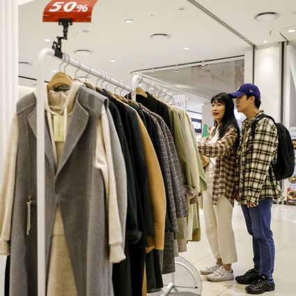 Shoppers look at discounted winter coats on sale in Seoul, but it’s the more expensive luxury brands like Louis Vuitton, Chanel and Dior that have been pulling the crowds. Photo: Reuters