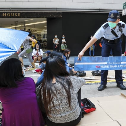 Police officers disperse domestic helpers as they gather in Central, Hong Kong, on their day off last April. Hong Kong has long been criticised for its treatment of people with brown skin, particularly helpers from the Philippines and Indonesia. Photo: Edmond So