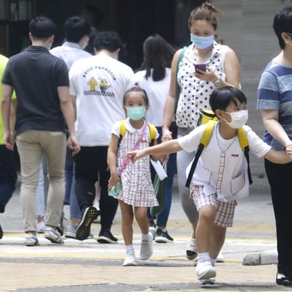 Primary school students leave their school premises in Causeway Bay. The government has suspended kindergarten and school, allowing students to begin the summer holiday early. Photo: Dickson Lee