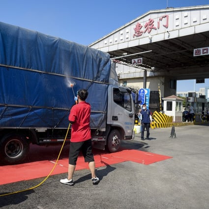 Staff disinfect a vehicle leaving the Xinfadi market in Fengtai district in Beijing on Tuesday. Photo: Xinhua