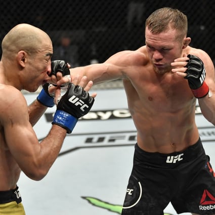 UFC bantamweight champion Petr Yan punches Jose Aldo in their title fight at UFC 251 on Fight Island, Abu Dhabi. Photo: USA Today