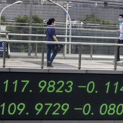 Stocks have been on fire in China. Here, people walk over a pedestrian bridge that features a monitor for stock exchange values in Shanghai. Photo: EPA-EFE