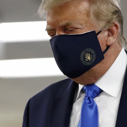 President Donald Trump wears a face mask as he walks down a hallway during a visit to Walter Reed National Military Medical Centre in Bethesda. Photo: AP Photo