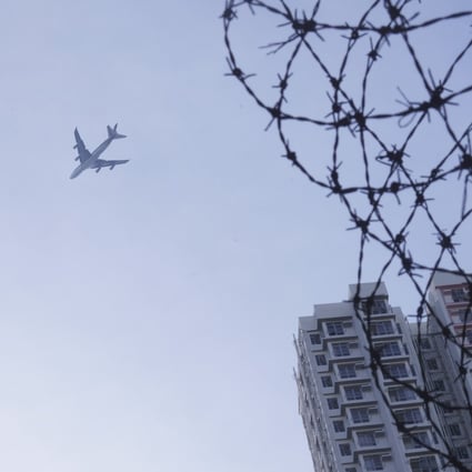 A plane flies over the government quarantine camp at Chun Yeung Estate in Fo Tan. Photo: Winson Wong