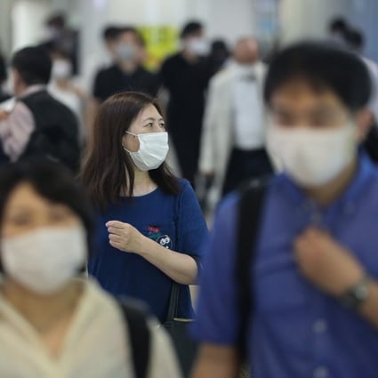 Commuters wearing face masks walk through Tokyo’s Shinjuku station. Photo: Xinhua