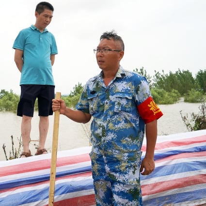 Hydraulic technician Liu Liangwu (right) remains on alert in Jiangzhou. Photo: Tom Wang
