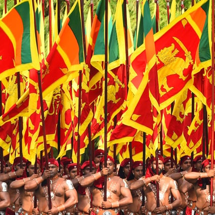 Sri Lankan military personnel march in traditional dress holding national flags during the country’s independence day in February 4. Photo: AFP