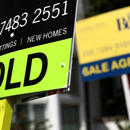 Estate agents’ boards outside a property in London. Photo: Reuters