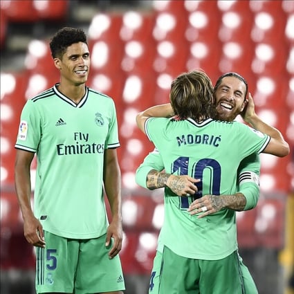 Real Madrid captain Sergio Ramos celebrates with his teammate Luka Modric after the win over Granada. Photo: AP