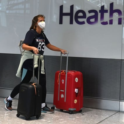 A passenger arrives at London Heathrow. The airport is taking measures to disinfect surfaces and retrain workers as “hygiene technicians” to reduce the risk of Covid-19 infections. Photo: AFP