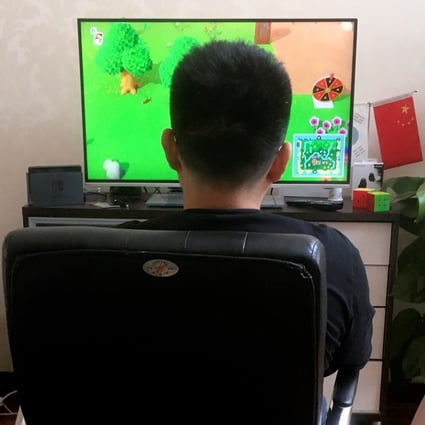 A man plays the game "Animal Crossing" on Nintendo Switch at his apartment in Beijing, China April 24, 2020. Photo: Reuters