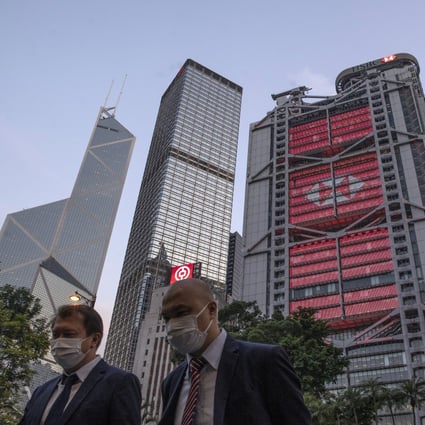 Pedestrians in Hong Kong’s Central business district, with the Bank of China Tower (left), Cheung Kong Center (second left) and HSBC headquarters building (cente) in the background, on Monday, April 27, 2020. Photo: Bloomberg