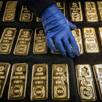 A worker arranges gold bars at a refinery smelter in Sydney, Australia on July 2. While investors revel in asset price gains, the canary in the coal mine is the continued rise in the price of gold, nagging strength in the bond markets, the weakness of oil and the stubborn strength of the US dollar. Photo: Bloomberg