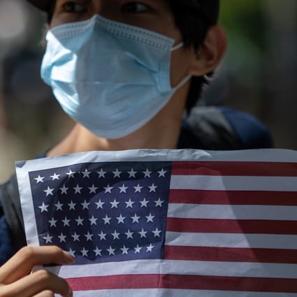 A man outside the offices of the US Consulate General to Hong Kong on July 4 displays a US flag as part of a protest against Hong Kong’s new national security law. Photo: EPA-EFE