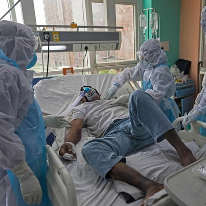 Doctors and nurses wearing protective gear look after a Covid-19 patient at a hospital’s intensive care unit in Greater Noida, India’s Uttar Pradesh, earlier this week. Photo: AFP