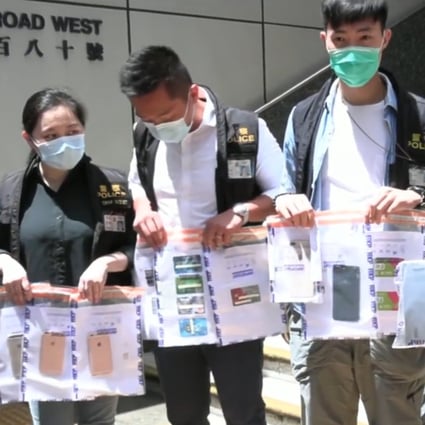 Police display seized iPhones and credit cards believed to be tied to an online scam involving air purifiers. Photo: Handout
