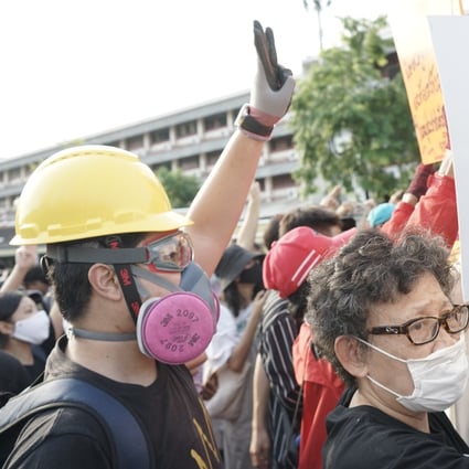 Thai protesters, some dressed in black and wearing hard helmets and gas masks, take part in an anti-government demonstration in Bangkok on July 18. Photo: Vijitra Duangdee