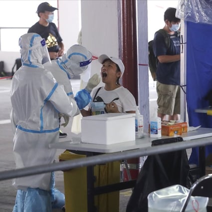 Medical workers take samples from taxi drivers at a temporary specimen collection point for Covid-19 testing. Photo: Edmond So