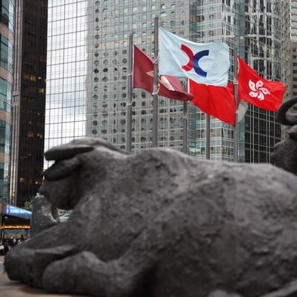 Bronze sculptures of bulls and the Hong Kong stock exchange flag at the Exchange Square in Central. Photo: Winson Wong