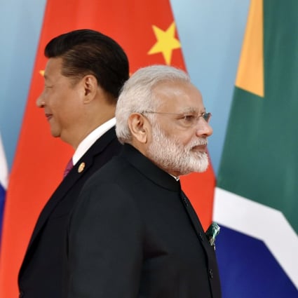 Chinese President Xi Jinping (left) and Indian Prime Minister Narendra Modi walk past each other during a photo session at the BRICS Summit in Xiamen, China, on September 4, 2017. Photo: AFP