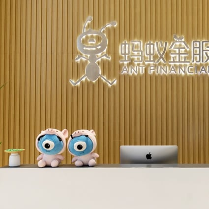 An employee works at a reception counter in the lobby of the Ant Group headquarters in Hangzhou, China. Photo: Bloomberg