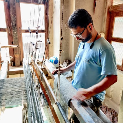 Aijaz Ahmad, 28, weaves pashmina shawls on a traditional loom at his home in central Srinagar, Kashmir, India. But he regrets ever learning the trade. Photo: Shoaib Shafi