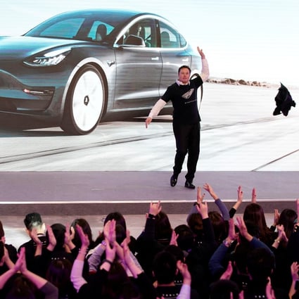Tesla’s chief executive officer Elon Musk throwing off his coat for a jig onstage during a delivery of Tesla’s China-made Model 3 cars in Shanghai on January 7, 2020. Photo: REUTERS