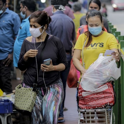 People shop at a market in Singapore on July 21, 2020. Photo: EPA-EFE