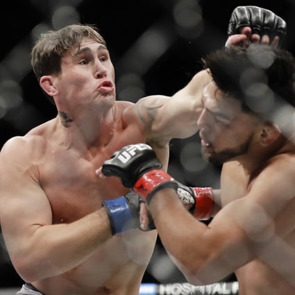 Darren Till punches Kelvin Gastelum during the second round of their middleweight bout at UFC 244. Photo: AP