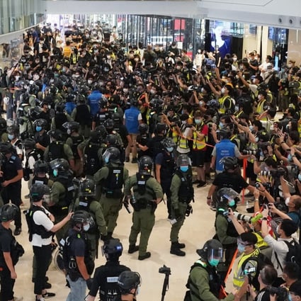Riot police, members of the media and activists at the Yoho mall in Yuen Long on Tuesday. Photo: Felix Wong
