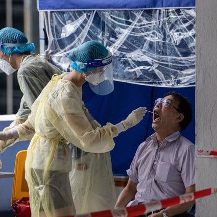 A taxi driver is tested for Covid-19 in a parking lot in Hong Kong. Photo: EPA-EFE