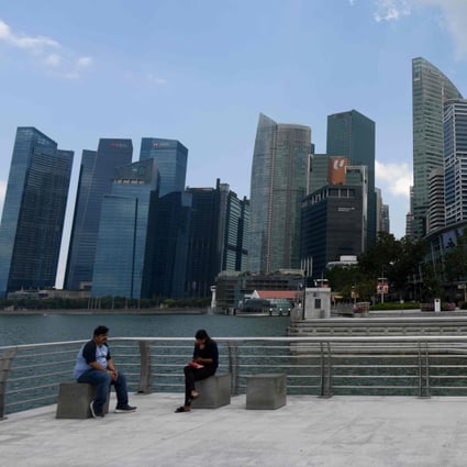 People sit near the Merlion statue in Singapore. After Jun Wei Yeo, pleaded guilty in the US to working for Chinese intelligence, Singaporeans have taken to social media to discuss the ramifications for the city state. Photo: AFP