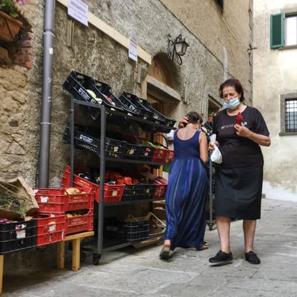 Residents of Italy’s Giglio Island shop in the steep alleys near the port. Photo: AP