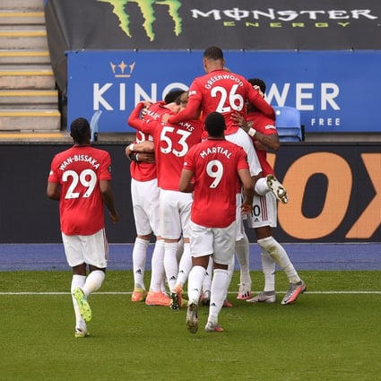 Manchester United players celebrate Bruno Fernandes’ penalty that put them in front against Leicester City. Photo: DPA