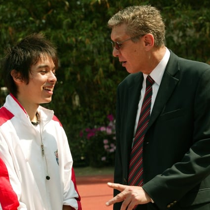 Diocesan Boys' School (DBS) old boy William Hill, Hong Kong's 400m record holder, talks to La Salle College student Sandro Bassetto at Wan Chai Sports Ground. Sandro came within a second of beating the record (49.1 seconds) at the 2004 interschool athletics finals. Photo: SCMP