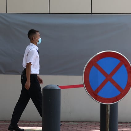 A Chinese security officer walks past the covered sign of the now-closed US consulate in Chengdu. Photo: Simon Song