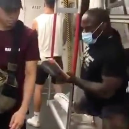 ONE Championship star Alain Ngalani prevents an unmasked passenger on Hong Kong's MTR system from sitting down. Photo: Instagram/Alain Ngalani