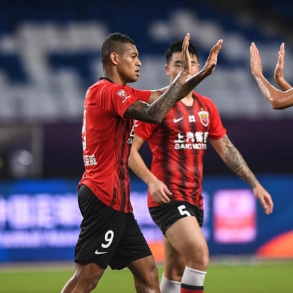 Ricardo Lopes (left) of Shanghai SIPG celebrates with his teammate Yu Hai (right) after scoring during the Chinese Super League first round match between against Tianjin Teda. Photo: Xinhua