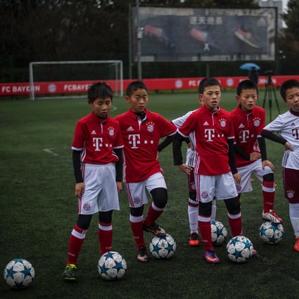Chinese boys in Bayern Munich jerseys take part in a training session after the opening ceremony of Bayern’s Shanghai office. Photo: AFP