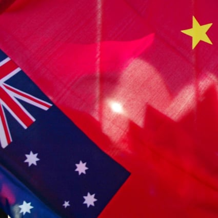 The shells of Sydney Opera House as seen through a Chinese flag. Photo: AFP