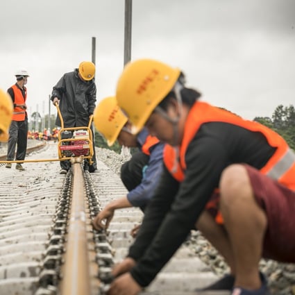 Workers from the China Railway No 2 Engineering Group assemble rails for the China-Laos railway in Vientiane, Laos, on June 18. The China-Laos railway is a project of the Belt and Road Initiative and aims to convert Laos from a landlocked country to a land-linked hub. Photo: Xinhua